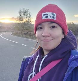 A person taking a selfie on a road
Description automatically generated